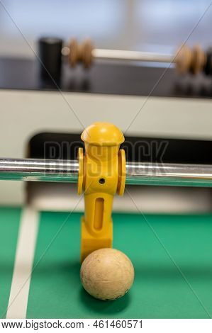Selective Focus On A Foosball Goalie Blocking The Ball Insider The Box.