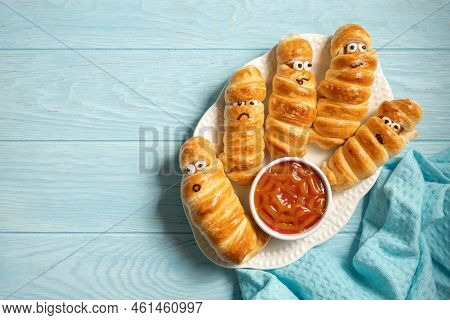 Fun Food For Kids. Mummy Sausages Scary Halloween Party Food Decoration Wrapped In Dough With A Bowl