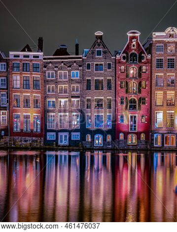 Amsterdam At Night With Dancing Colorful House At The Amsterdam Canals