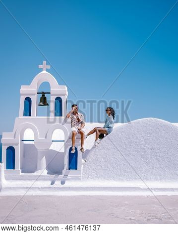 Couple Of Men And Women On Vacation In Santorini Greece, Couple Visit Oia Santorini