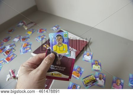 Bauru, Brazil - 12.09.22: Closeup Of Hand Holding Collectible Football Player Sticker To Stick At Pa