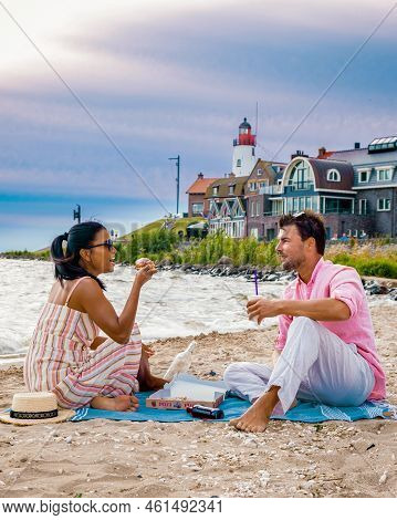 Couple Men And Women Eating Pizza On The Beach