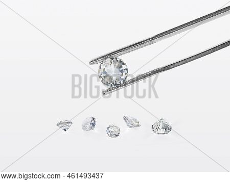 Brilliant Cut Diamond Held By Tweezers. For Design