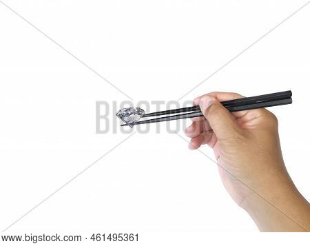 New Idea Concept Male Hand With Chopsticks Holds Dazzling Diamond On A White Background