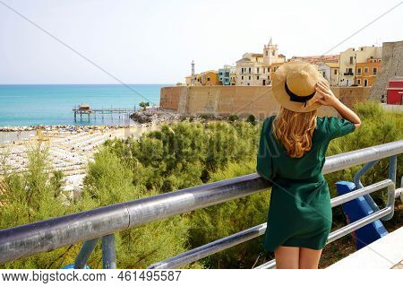 Summer Holiday In Italy. Back View Of Young Woman With Hat And Dress In Termoli Village, Molise, Ita