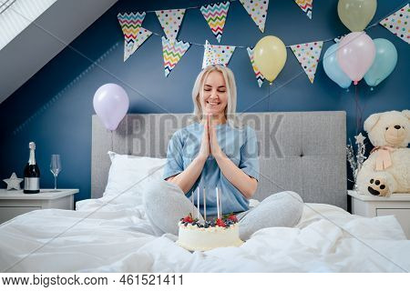 Happy Emotional Woman In Pajama And Party Cap After Blowing Out The Candles On Birthday Cake, Sittin