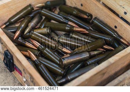 Closeup View Of Plent Of Rifle Ammo Bullets In A Wooden Box. High Quality Photo