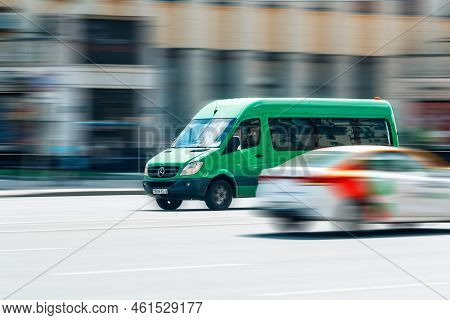 Green Mercedes-benz Sprinter Minibus Van Moving On City Speedway Road. Commercial Auto In Fast Motio