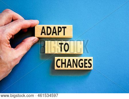 Adapt To Changes Symbol. Concept Words Adapt To Changes On Wooden Blocks. Businessman Hand. Beautifu