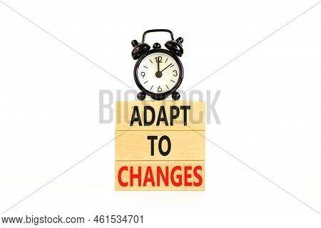 Adapt To Changes Symbol. Concept Words Adapt To Changes On Wooden Blocks. Black Alarm Clock. Beautif