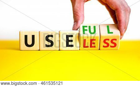 Useful Or Useless Symbol. Concept Words Useful Or Useless On Wooden Cubes. Businessman Hand. Beautif