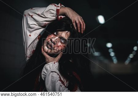 Screaming Zombie Female Broken Face With Blood Grabs Her Head To Twist It Off, Horror Bloodthirsty W