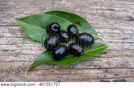 Top View Of Malabar Plum Or Syzygium Cumini With Leaves Isolated On Wooden Background, Also Known As
