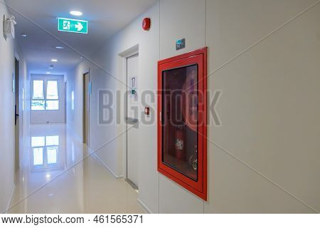 Fire Extinguisher System On The Wall With Fire Exit Door Sign For Emergency. Stairwell Fire For Esca