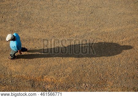 Country Man Walking With His Shadow Behind Him.
