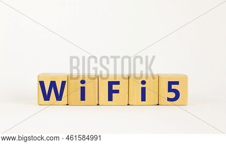 Wifi 5 Symbol. The Concept Word Wifi 5 On Wooden Cubes. Beautiful White Table, White Background, Cop