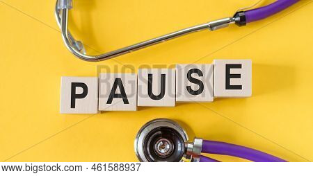 Wooden Blocks With The Word Pause. Break Time Concept In Medicine. A Break During Work. Time To Rela