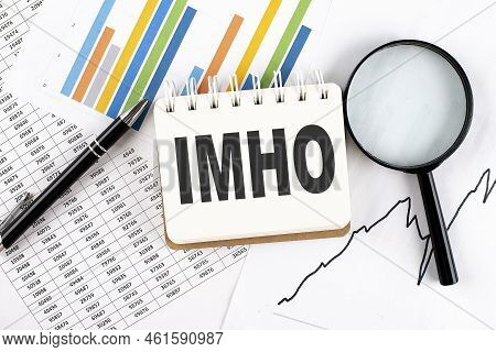 Imho Text On Notebook On Graph Background With Pen And Magnifier