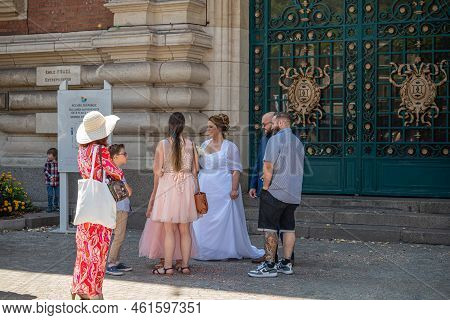 Europe, France, Dunkerque - July 9, 2022: Small Group Of People Gather Around Bride In White Waiting