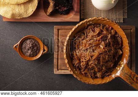 Tinga De Res. Typical Mexican Dish Prepared Mainly With Shredded Beef, Onion And Dried Chilies. It I