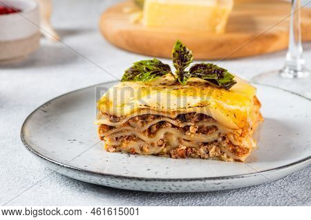 Piece Of Tasty Hot Lasagna On Light Background. Traditional Italian Lasagna. Italian Food. Close Up 
