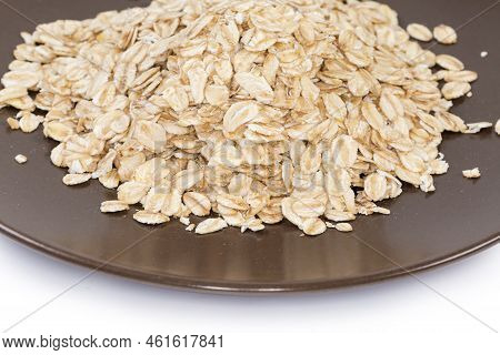 Heap Of The Raw Thick-rolled Oats On The Brown Dish, Close-up In Selective Focus