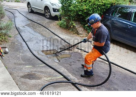Menthon Saint Bernard, France - September 09 2021: A Professional Worker Is Busy With A Pump Car And