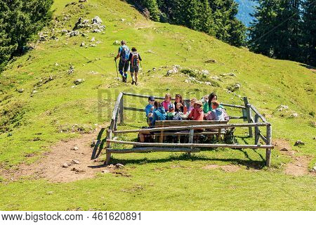 Feistritz An Der Gail, Austria - August 10, 2022: A Group Of Young Hikers Take A Lunch Break In Moun