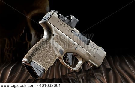 Semi Automatic Pistol With Skull Behind To Signify A Ghost Gun