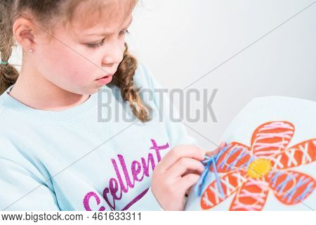 Little Girl Learning How To Sew With Sewing Craft Kit For Kids.
