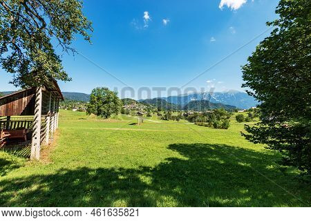 Rural Landscape With Vertical Hay Rack (kozolec - Hayrack) On Green Meadow. Triglav National Park, J
