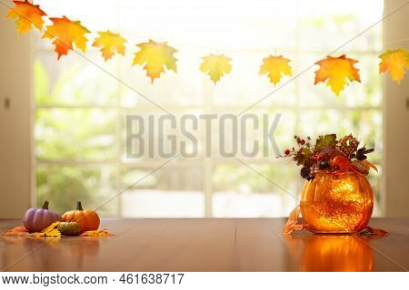 Autumn Home Decoration. Pumpkin Lantern For Thanksgiving Table Setting. Orange Leaves And Flowers Ar