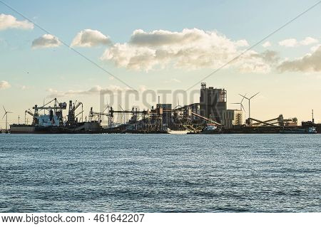 Rotterdam, Netherlands - November 22 2021 : Iron Ore Is Being Unloaded By Huge Cranes In Het Industr