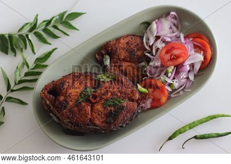 Crispy Surmai Fish Fry. Shallow Fried King Fish In Kerala Style Served With Onion Tomato Salad Calle