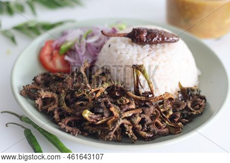 White Rice Meal Along With Fried Bitter Gourd And Onion Tomato Salad Called Challas Served With Samb