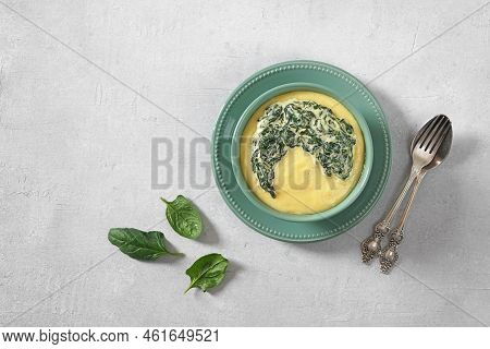 Vegetarian Lunch, Polenta With Cooked Spinach Cream Sauce In Green Plate, Top View, Copy Space