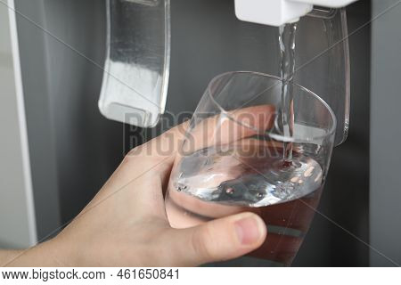 Woman Filling Glass With Water Cooler, Closeup. Refreshing Drink