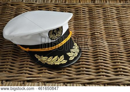 Peaked Cap With Accessories On Wicker Surface, Space For Text
