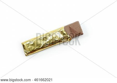 Chocolate Bar In Opened Gold Aluminum Foil Isolated On White Background