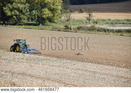 Thür, Germany - 09 08 2022: Tractor Plowing And Attracting Birds
