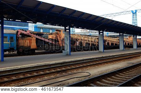 Tracklayer Train Full Loaded With Gravel Near The Platform At The Railway Station