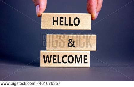 Hello And Welcome Symbol. Concept Words Hello And Welcome On Wooden Blocks. Businessman Hand. Beauti