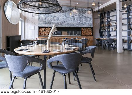 Latvia, Riga, August, 2022: Stylish Modern Interior Aqua Luna Restaurant With Fireplace In Andrejost