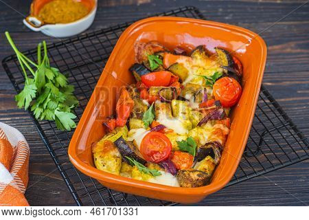 Baked Vegetable Mix With Spices And Suluguni Cheese In A Ceramic Form On A Dark Wooden Background. G