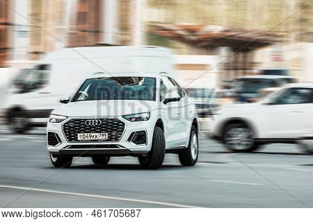 Suv Car In Motion. Q5 Sportback Third Generation Moving On The Street. White Audi Q5 Sportback Is Tu