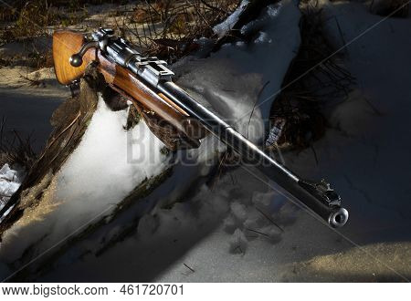 Old Rife Froim World War Ii Sporterized For Hunting On A Snowy Log