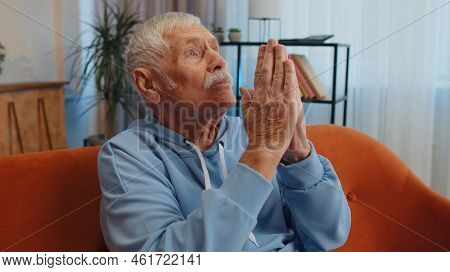 Please, God Help. Man Praying Sincerely With Folded Arms, Looking Upward And Making Wish, Asking Wit