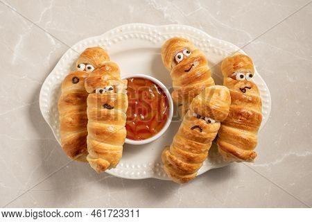 Fun Food For Kids. Mummy Sausages Scary Halloween Party Food Decoration Wrapped In Dough With A Bowl
