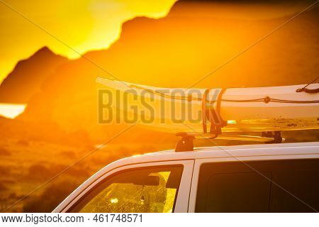 Car Van With Canoe On Top Roof Against Sunset Sky. Active Lifestyle, Vanlife Concept.