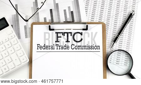 Paper With Ftc -federal Trade Commission On Chart With Calculator,pen And Magnifier
